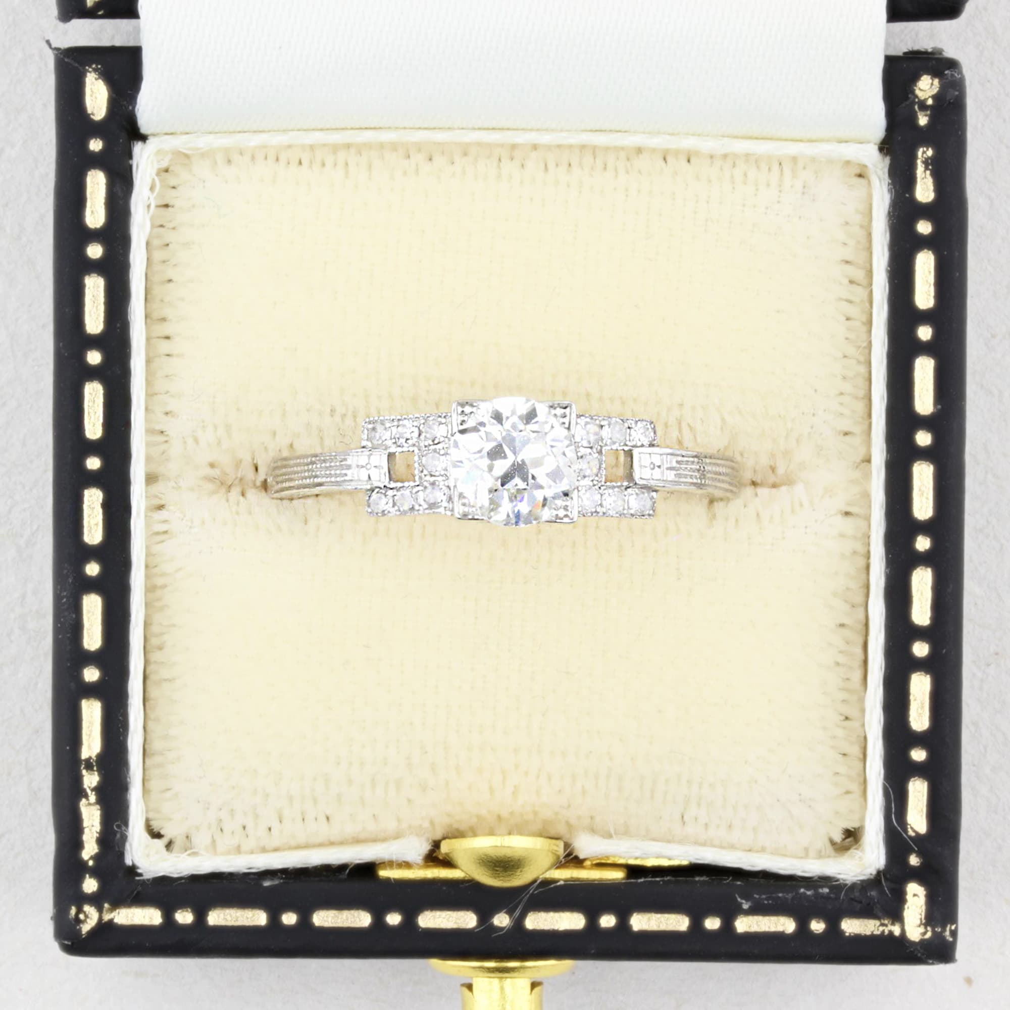 Diamond ring in a decorative box with gold accents