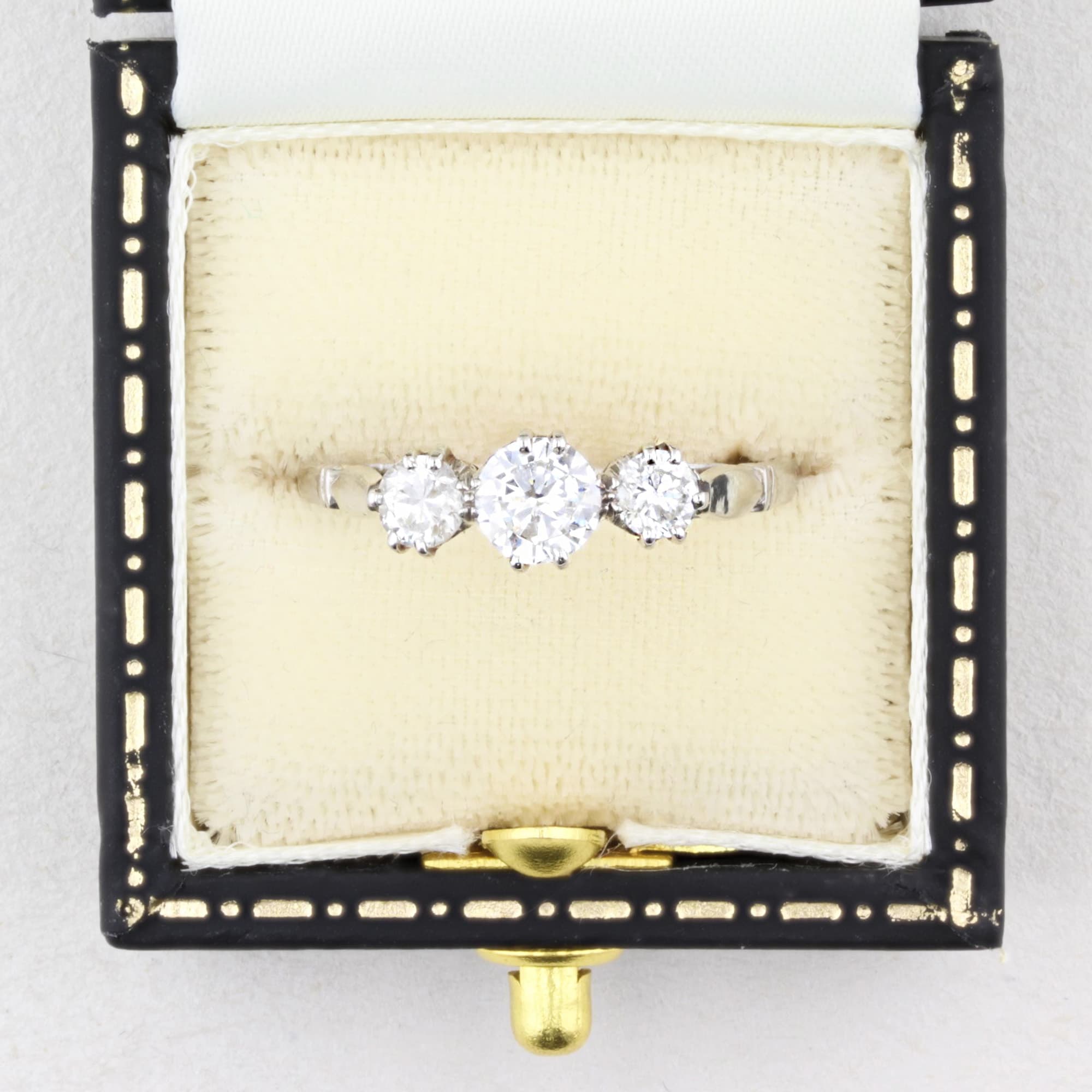 Three diamond rings in a vintage box on a white background