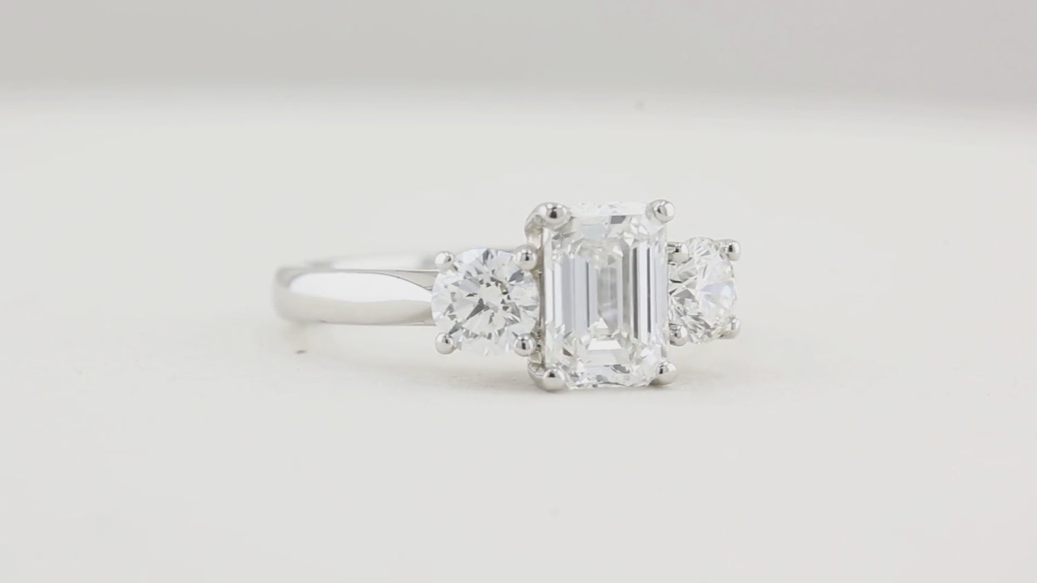 1.80ct Emerald Cut and Round Diamond Three Stone Engagement Ring