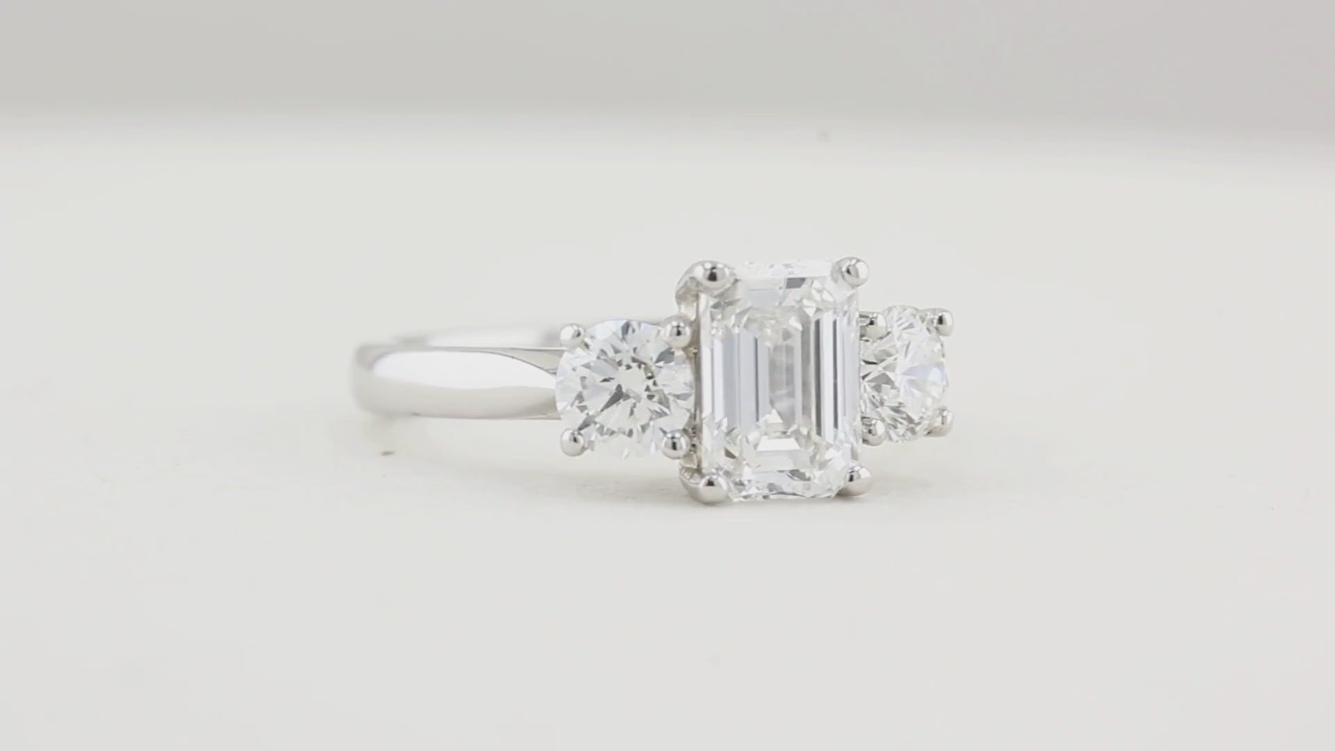 1.80ct Emerald Cut and Round Diamond Three Stone Engagement Ring